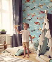 Boy playing with wooden aeroplane in scandinavian bedroom interi