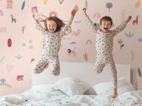 Kids paljamas party in white bedroom interior