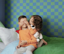 Smiling cute children a little girl and a boy in bright orange p