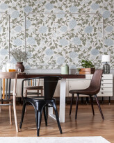 Colorful chairs at wooden table in grey rustic dining room inter